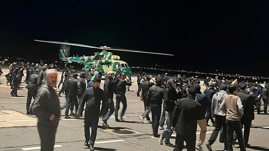People in the crowd walk shouting antisemitic slogans at an airfield of the airport in Makhachkala, Russia, Monday, Oct. 30, 2023.(AP)