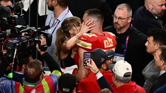 US singer-songwriter Taylor Swift kisses Kansas City Chiefs' tight end #87 Travis Kelce after the Chiefs won Super Bowl LVIII against the San Francisco 49ers(AFP)