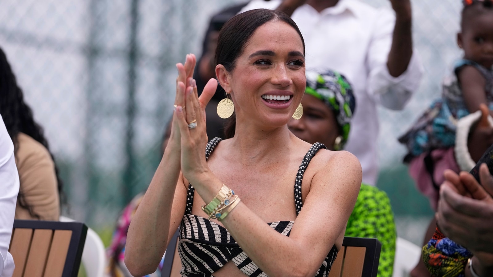 Meghan Markle's diamond cross necklace, allegedly from Princess Diana's collection, under scrutiny after Nigeria visit