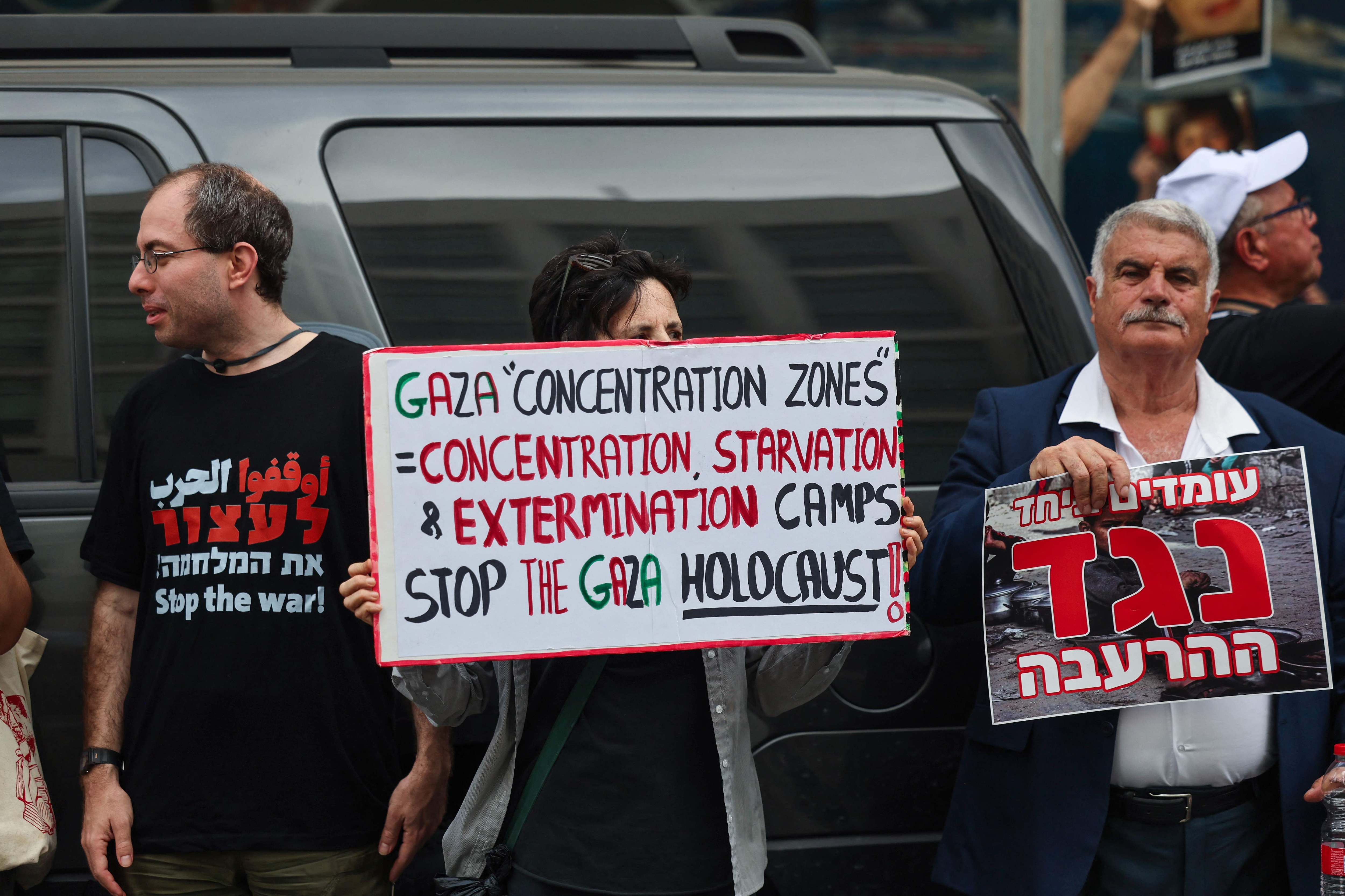 Protesters lift placards against the war in Gaza during a rally in front of the US consulate in the central Israeli city of Tel Aviv (AFP)